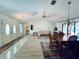 Spacious living room featuring vaulted ceilings, wood floors, and direct access to the outdoor pool area at 1305 Alton Rd, Port Charlotte, FL 33952
