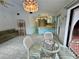 Open-concept living and dining area featuring a dining table and chairs with a couch and kitchen access at 1305 Alton Rd, Port Charlotte, FL 33952