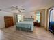 Bright main bedroom featuring sliding door access, natural light and a light-colored ceiling fan at 1305 Alton Rd, Port Charlotte, FL 33952