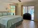 Large main bedroom highlighting natural light and access to outdoor pool area at 1305 Alton Rd, Port Charlotte, FL 33952