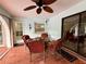 Charming outdoor patio with red-cushioned seating and tiled flooring, ideal for relaxed outdoor dining at 1305 Alton Rd, Port Charlotte, FL 33952