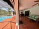 Spacious patio area with brick flooring, ceiling fans, and access to a screened-in pool area at 1305 Alton Rd, Port Charlotte, FL 33952