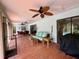 Covered patio with ceiling fan, dining area and seating, perfect for outdoor relaxation at 1305 Alton Rd, Port Charlotte, FL 33952