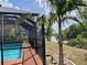 Enjoy backyard water views from the screened-in pool with an attached deck at 1305 Alton Rd, Port Charlotte, FL 33952