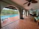 Spacious outdoor living area adjacent to a sparkling pool, perfect for entertaining and relaxation at 1305 Alton Rd, Port Charlotte, FL 33952