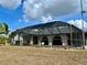 The screened in pool enclosure is in the back of the house at 1305 Alton Rd, Port Charlotte, FL 33952