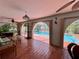 Covered patio area with access to screened pool, complemented by comfortable seating at 1305 Alton Rd, Port Charlotte, FL 33952