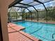 The screened-in pool area has a brick deck and offers beautiful outdoor views at 1305 Alton Rd, Port Charlotte, FL 33952