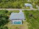 Take a tour of the property with an aerial view of the screened-in pool at 13235 Essman Ave, Port Charlotte, FL 33953