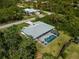 Aerial view of the property with screened-in pool and a well-maintained roof at 13235 Essman Ave, Port Charlotte, FL 33953