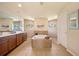 Bright bathroom featuring a soaking tub, tiled shower, double vanity, and natural light at 13235 Essman Ave, Port Charlotte, FL 33953