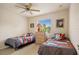 This bedroom has two beds, a ceiling fan, and a window for natural light at 13235 Essman Ave, Port Charlotte, FL 33953