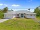 Well-maintained single-story home with a two-car garage and neatly landscaped front yard at 13235 Essman Ave, Port Charlotte, FL 33953