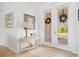 Bright foyer features a console table, glass doors, and neutral decor, creating an inviting entrance at 13235 Essman Ave, Port Charlotte, FL 33953