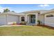 Charming home featuring a well-manicured lawn, tasteful landscaping, and a welcoming entrance at 13235 Essman Ave, Port Charlotte, FL 33953