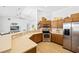 Bright kitchen with a breakfast bar, stainless appliances, plenty of counter space and wood cabinetry at 13235 Essman Ave, Port Charlotte, FL 33953
