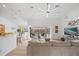 Bright living room with large windows, an oversized couch, and a view of the outdoor pool area at 13235 Essman Ave, Port Charlotte, FL 33953