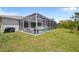 Enclosed pool with ample seating offers a perfect backyard retreat at 13235 Essman Ave, Port Charlotte, FL 33953
