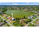 Wide aerial view of a waterfront property with a terracotta roof and large lake at 149 Albert Ln, Port Charlotte, FL 33954