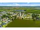 Wide aerial view of a waterfront property with a terracotta roof and large lake at 149 Albert Ln, Port Charlotte, FL 33954