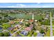 Aerial view shows the single Gathering home nestled within a community of homes near a lake at 149 Albert Ln, Port Charlotte, FL 33954
