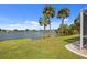 Picturesque backyard with palm trees and water views, providing a serene and tropical outdoor experience at 149 Albert Ln, Port Charlotte, FL 33954