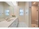Bright bathroom with a walk-in shower, tiled floors, and ample natural light at 149 Albert Ln, Port Charlotte, FL 33954