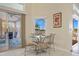 Breakfast nook with glass table with seating, tile floors, and backyard view at 149 Albert Ln, Port Charlotte, FL 33954