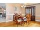 A dining room featuring a wood table with seating and a beautiful china cabinet on hardwood floors at 149 Albert Ln, Port Charlotte, FL 33954