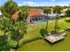 A view of the pool, private dock, and lush lawn leading to the waterfront property at 149 Albert Ln, Port Charlotte, FL 33954
