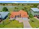 Aerial view of the home showing its terracotta roof, well-kept lawn and waterfront access at 149 Albert Ln, Port Charlotte, FL 33954