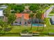 A view of the pool, private dock, and lush lawn leading to the waterfront property at 149 Albert Ln, Port Charlotte, FL 33954