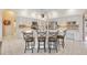 Island kitchen with quartz countertops, stainless appliances, and ample white cabinets at 149 Albert Ln, Port Charlotte, FL 33954