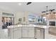 Open kitchen featuring quartz countertops, stainless steel dishwasher, and view of fireplace and backyard at 149 Albert Ln, Port Charlotte, FL 33954