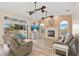 Bright living room featuring a fireplace, fan lights, and sliding glass doors to the pool at 149 Albert Ln, Port Charlotte, FL 33954