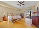Spacious bedroom features a ceiling fan, wood floors, dresser, and a sliding glass door to pool at 149 Albert Ln, Port Charlotte, FL 33954