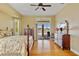 Large bedroom with wood floors, ceiling fan, dresser, and sliding glass doors to the pool at 149 Albert Ln, Port Charlotte, FL 33954