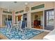 Cozy lanai with table and chairs, perfect for outdoor dining with a view of the pool and backyard at 149 Albert Ln, Port Charlotte, FL 33954