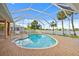 Enclosed swimming pool with brick pavers, tropical plants, and a lake view at 149 Albert Ln, Port Charlotte, FL 33954