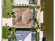 Aerial view of a waterfront home featuring a screened lanai and boat dock on the canal at 15762 Aqua Cir, Port Charlotte, FL 33981