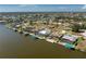 Aerial view showcases waterfront homes with boat docks in a scenic canal community at 15762 Aqua Cir, Port Charlotte, FL 33981
