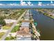 Scenic aerial view of canal-front homes with lush landscaping, boat docks, and ocean views in a beautiful neighborhood at 15762 Aqua Cir, Port Charlotte, FL 33981