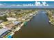 Aerial view of waterfront homes along a canal featuring private docks and boat lifts at 15762 Aqua Cir, Port Charlotte, FL 33981