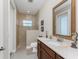 Neutral bathroom featuring a tiled shower, a dark wood vanity, and seahorse decor at 15762 Aqua Cir, Port Charlotte, FL 33981