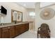 Bathroom featuring a dark wood vanity, granite counters, and a tiled shower at 15762 Aqua Cir, Port Charlotte, FL 33981
