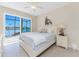 Bright bedroom featuring a ceiling fan, a large bed, and sliding glass doors to a patio at 15762 Aqua Cir, Port Charlotte, FL 33981