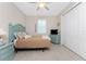 Bedroom with a full bed, side table, dresser, and a window with wooden shutters at 15762 Aqua Cir, Port Charlotte, FL 33981