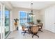 Dining area features a glass top table, four rattan chairs, and view of the pool and waterfront at 15762 Aqua Cir, Port Charlotte, FL 33981