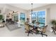 Dining area with sliding glass doors that open up to an outdoor pool and water view at 15762 Aqua Cir, Port Charlotte, FL 33981