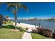 Beautiful backyard view of a private dock and water access surrounded by tropical landscaping at 15762 Aqua Cir, Port Charlotte, FL 33981